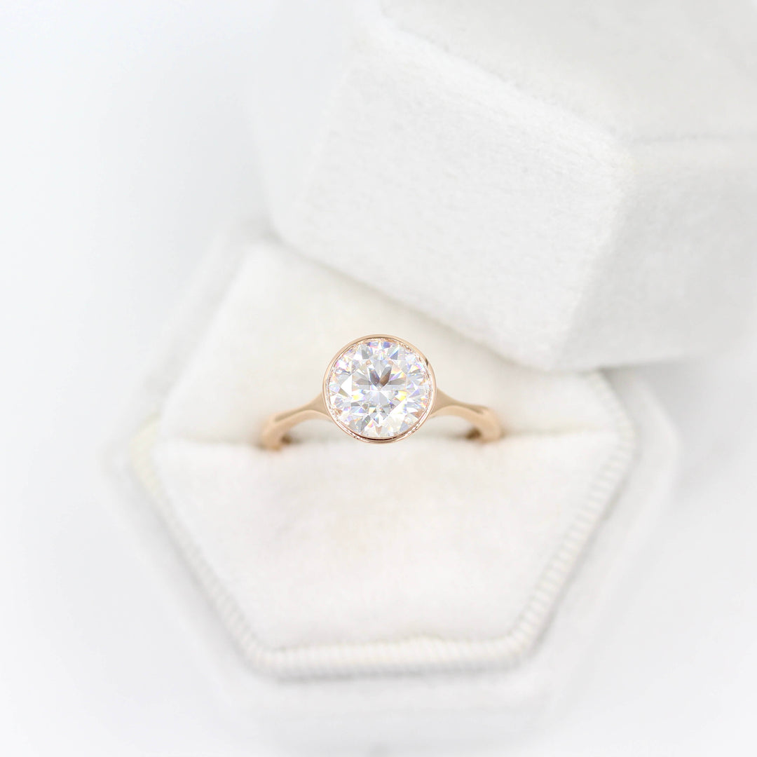 The Stevie Ring (Round) in Rose Gold with 2ct Moissanite in a white velvet ring box