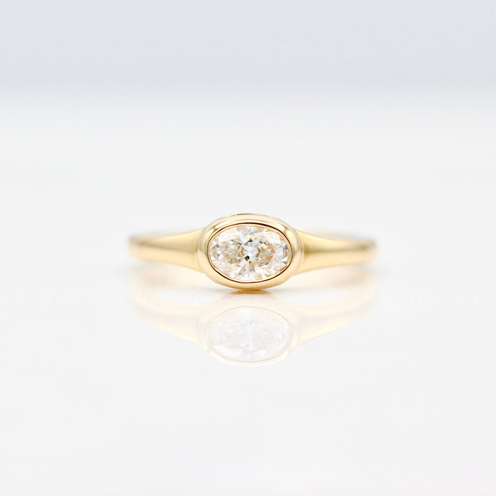 East-West Oval Diamond Pinky Ring in Yellow Gold on a White Background