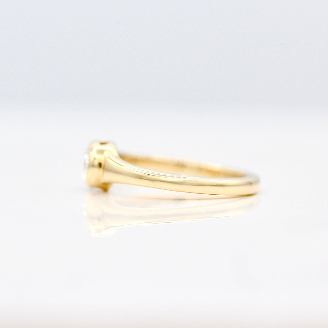 A side view of The Baby Billie Pinky Ring band in yellow gold