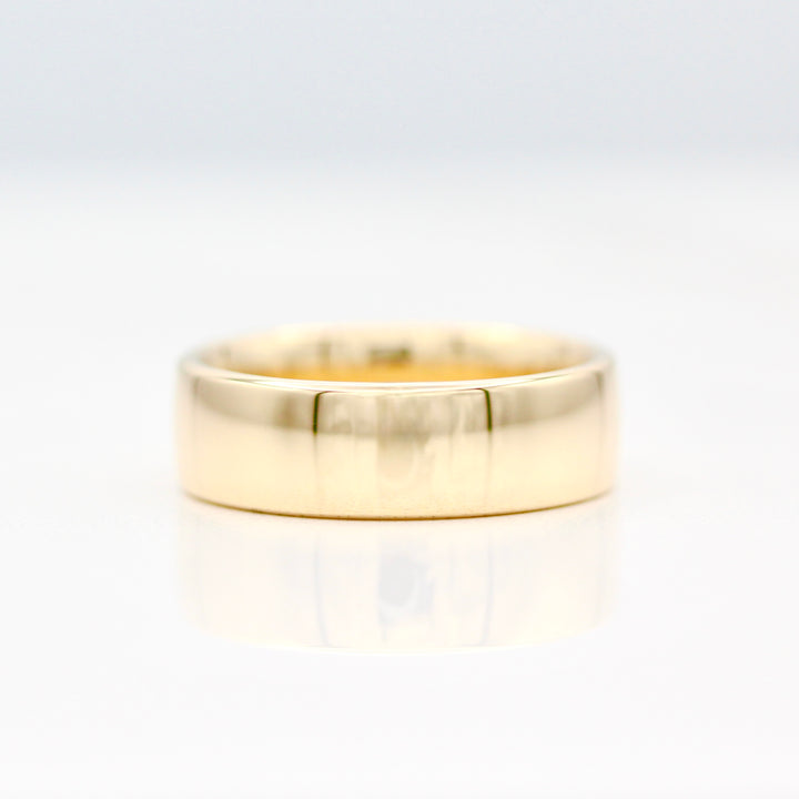 6.5mm Yellow gold plain sleek band on a white background