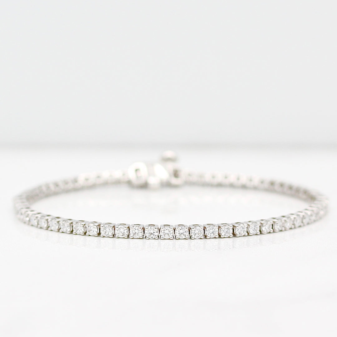 Diamond tennis bracelet in white gold on a white background