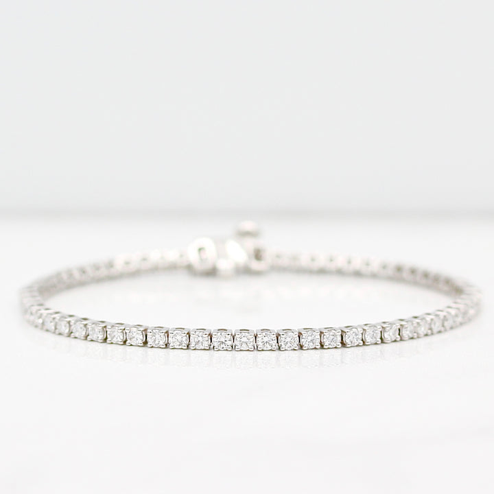 Diamond tennis bracelet in white gold on a white background
