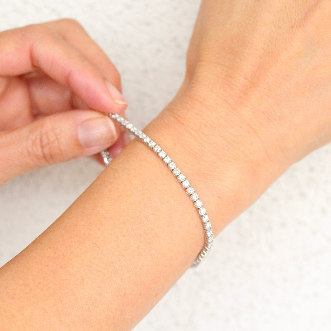 The Classic Lab-Grown Diamond Tennis Bracelet in White Gold shown close up on a hand with white background