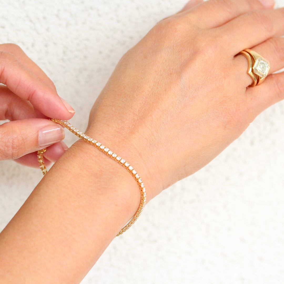 The Classic Lab-Grown Diamond Tennis Bracelet in Yellow Gold shown on a glowy hand