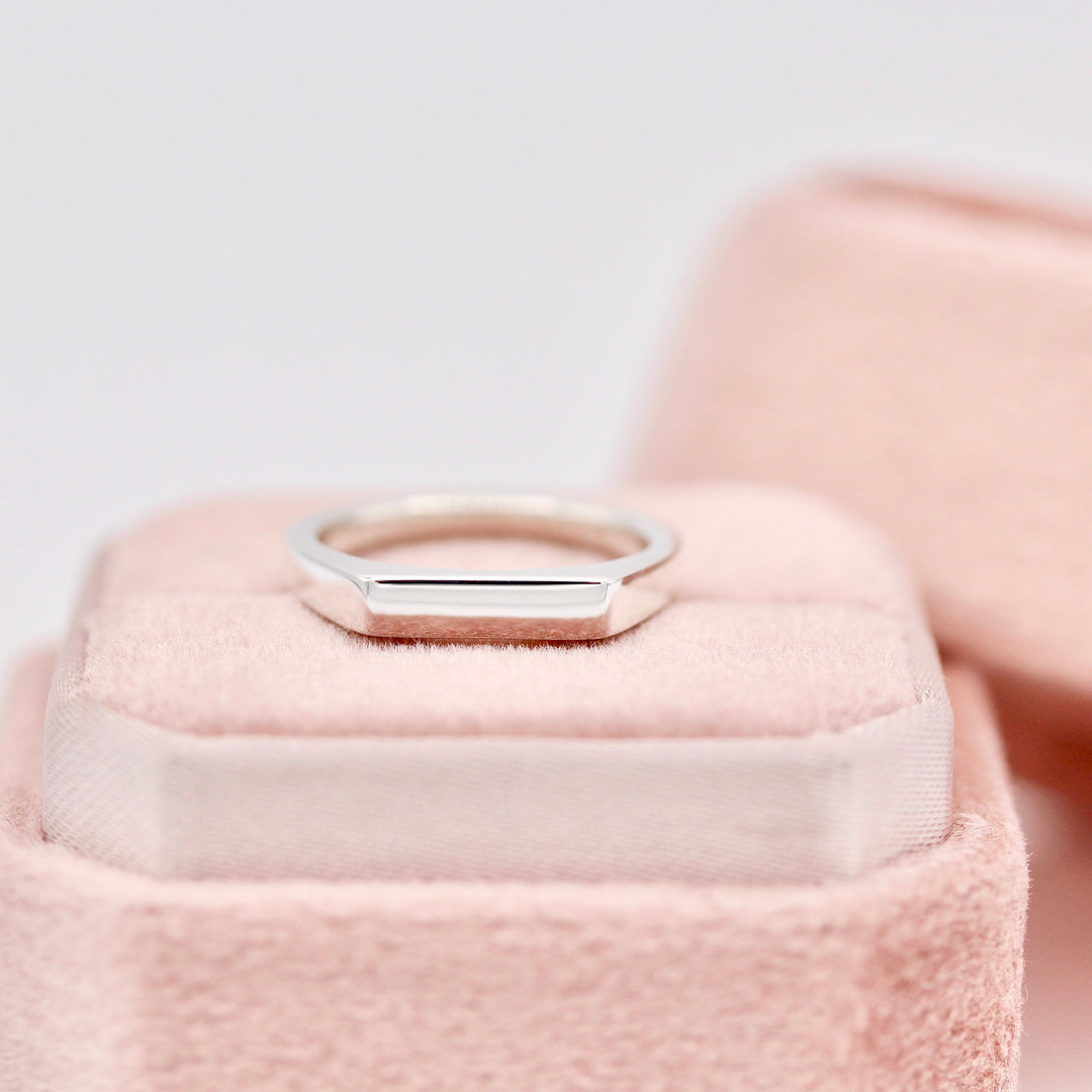 The Eleanor Pinky Ring resting on a Pink Velvet Ring Box