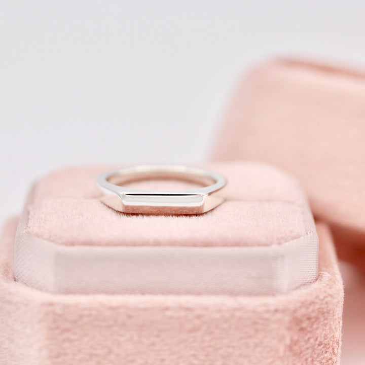 The Eleanor Pinky Ring resting on a Pink Velvet Ring Box