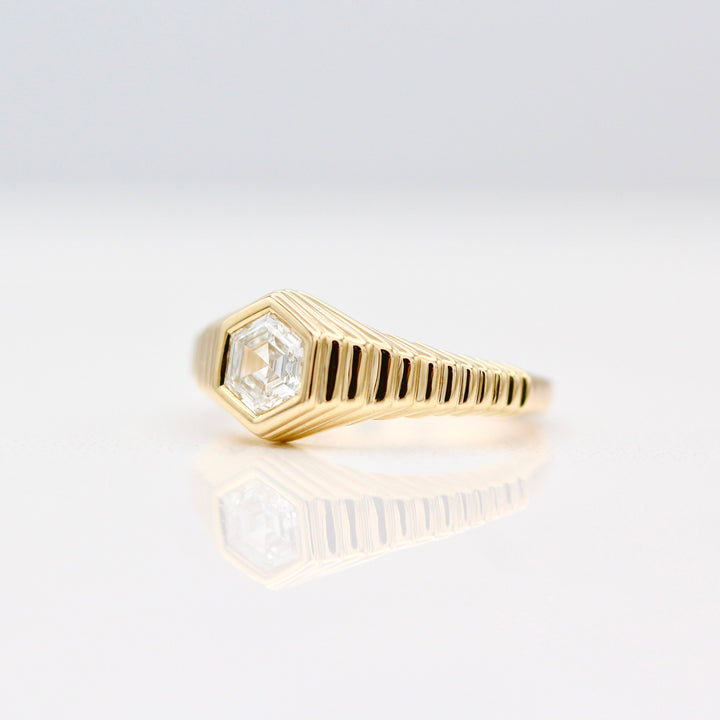 An angled view of The Fitz Pinky Ring in Yellow Gold on a White background