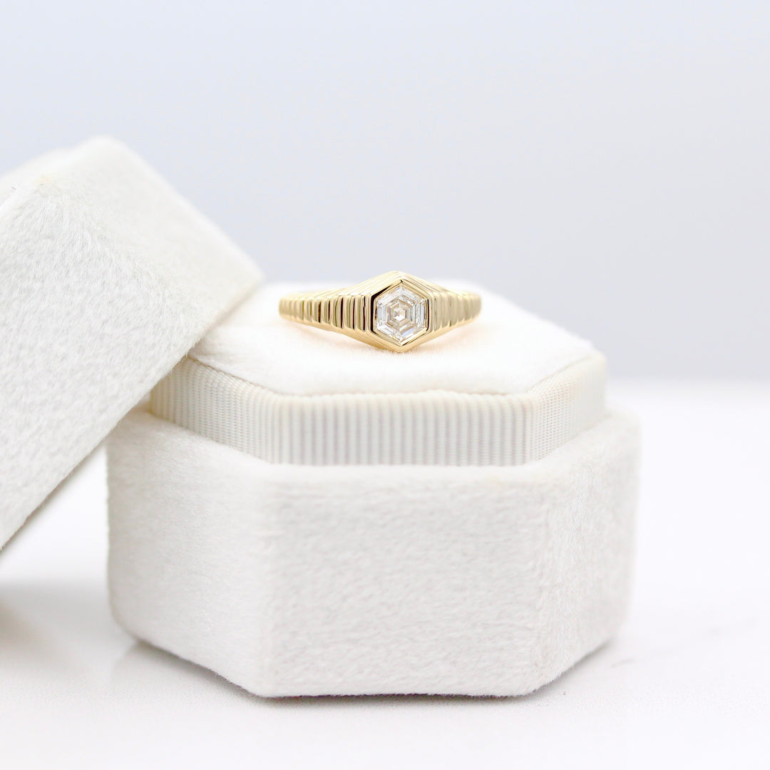 The Fitz Pinky Ring resting on a White Velvet Ring Box in Yellow Gold