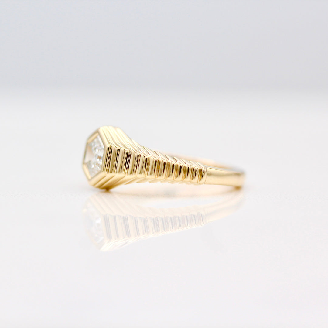 The Fitz Pinky Ring in Yellow Gold with tapered step band on a White background