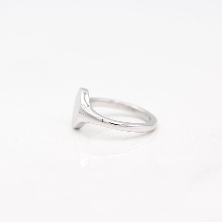 Sterling Silver Oval Signet Pinky Ring with Tapered Band on a White Background