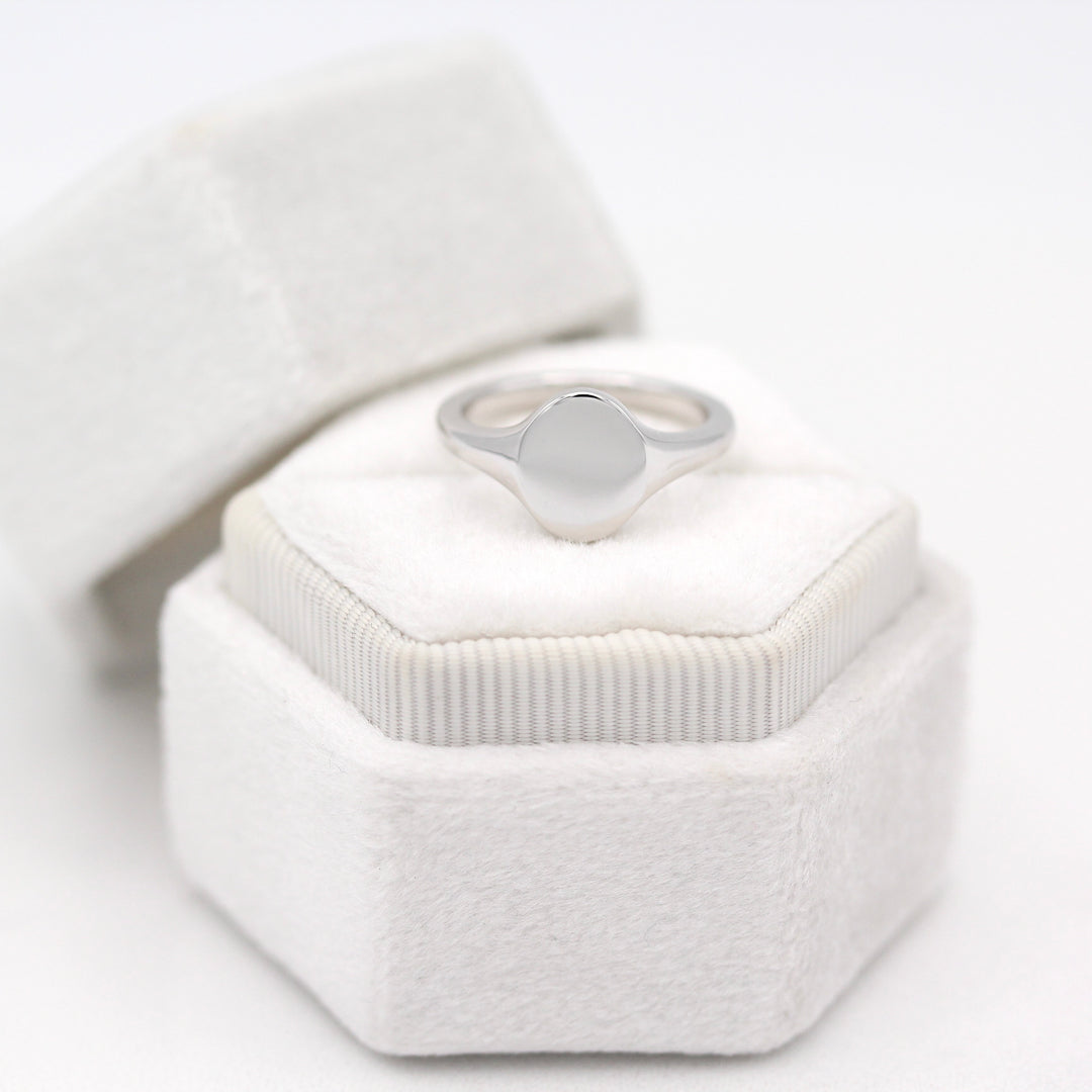 The Katherine Pinky Signet Oval Ring on a White Velvet Ring Box in Sterling Silver