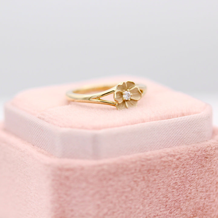 The Poppy Flower Pinky Ring on a Blush Pink Velvet Ring Box.