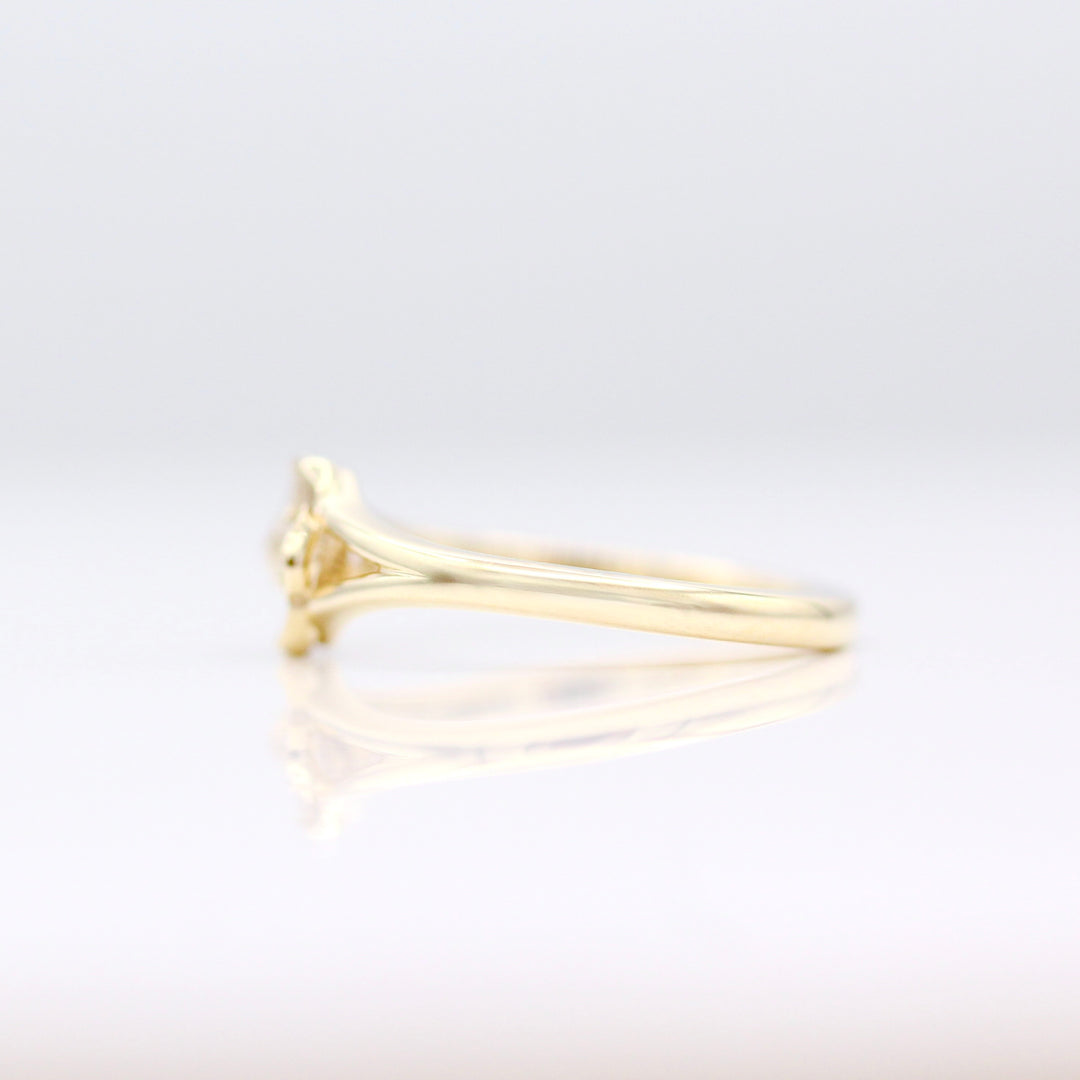 A side view of the Poppy Pinky Ring in Yellow Gold on a White Background