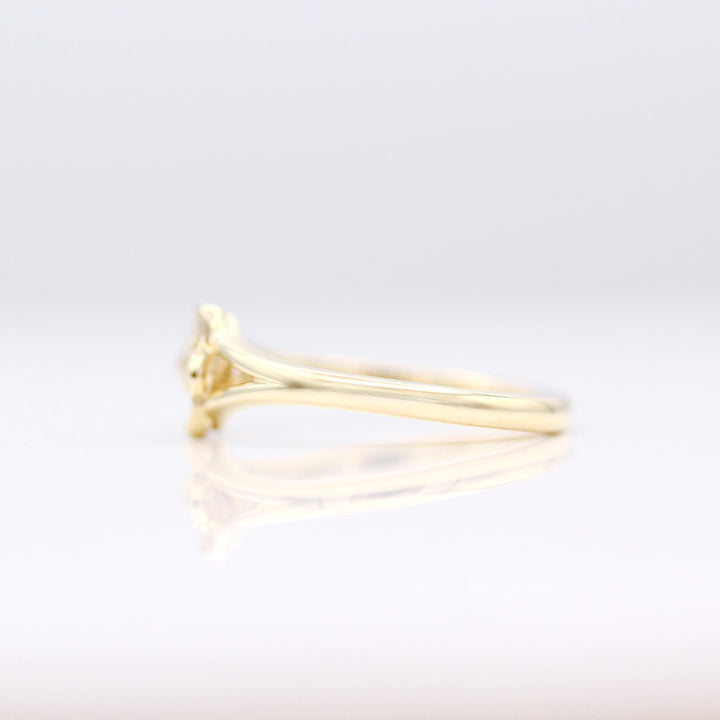 A side view of the Poppy Pinky Ring in Yellow Gold on a White Background