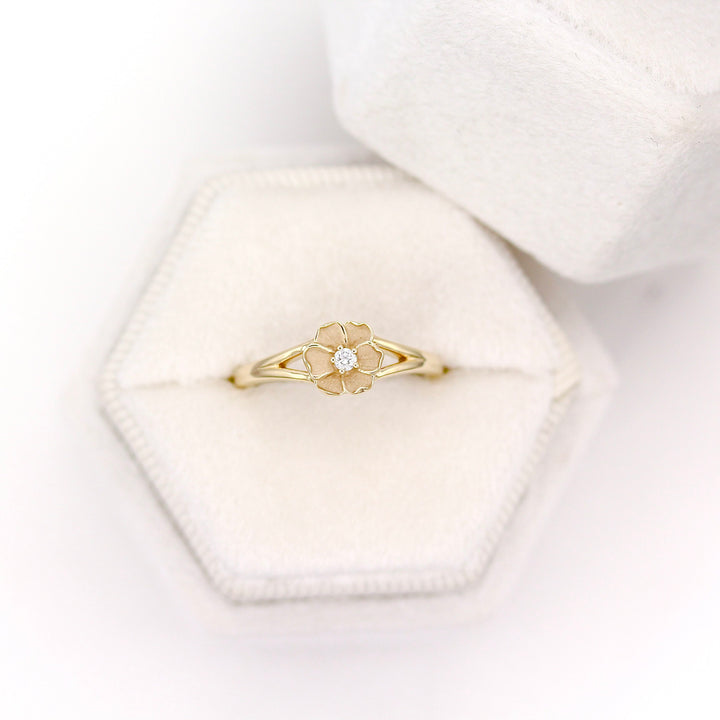 The Poppy Pinky Ring in Yellow Gold placed in a White Velvet Ring Box with White background