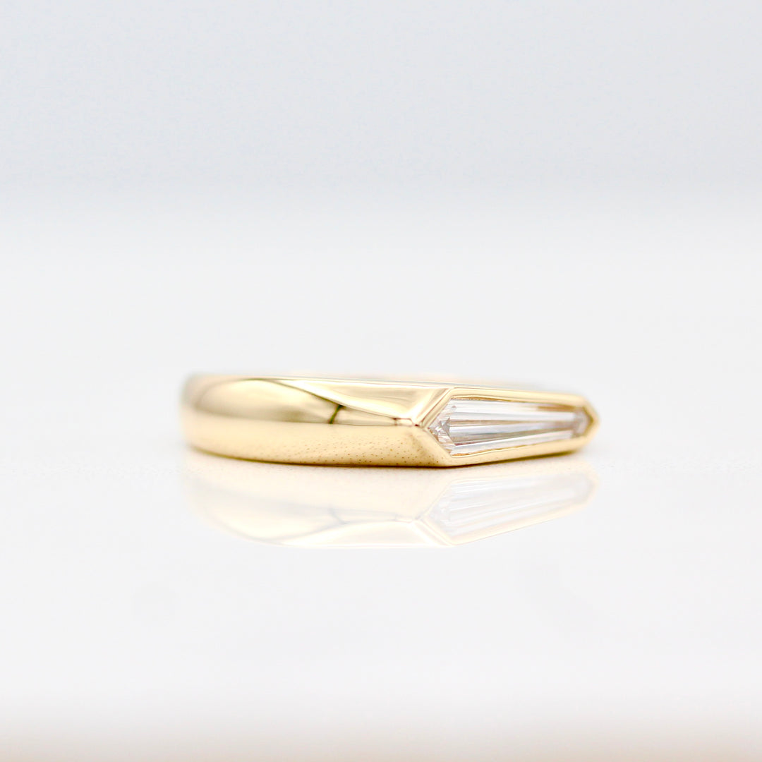 An angled view of the yellow gold shield cut diamond ring