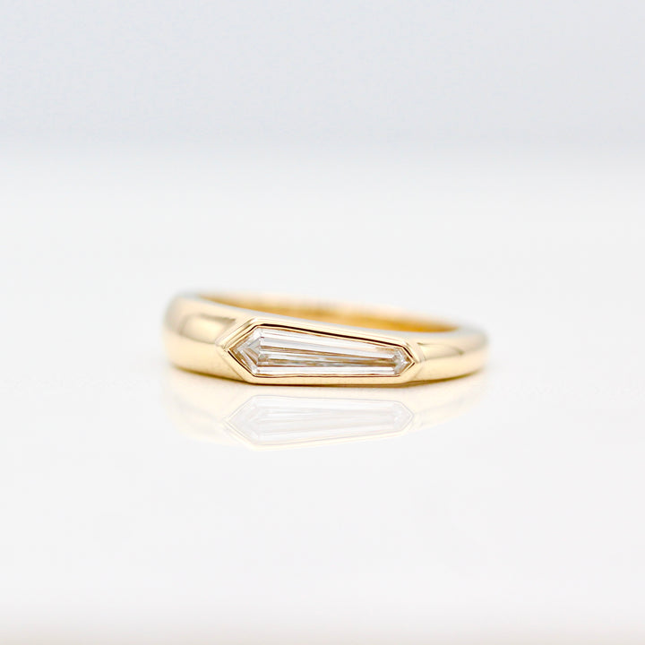 Bezel set Elongated Shield cut Diamond Pinky Ring in Yellow Gold on a White Background