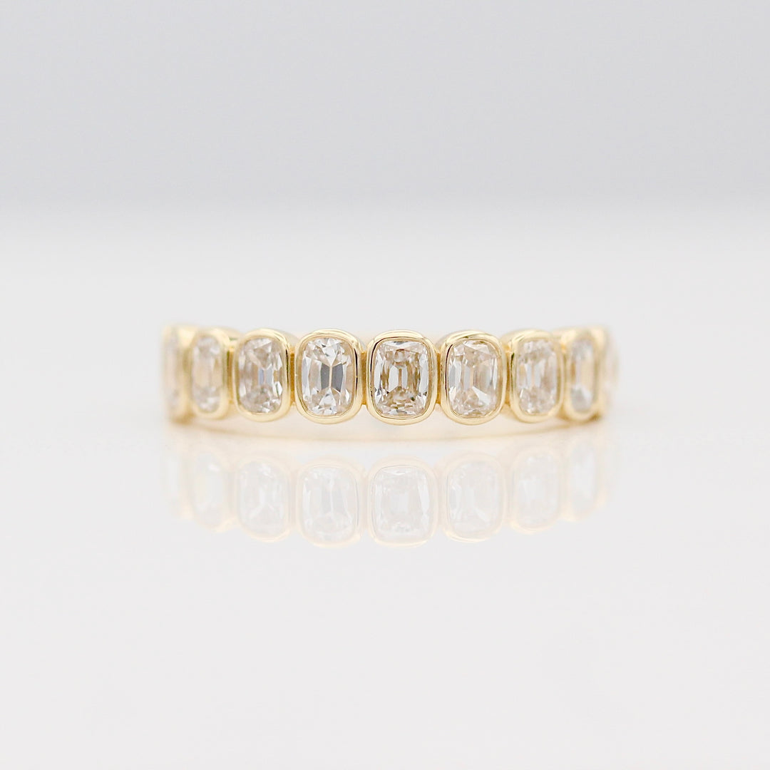 Yellow Gold Bezel set Wedding Band with Old Miner cut Lab-Grown Diamonds on a Neutral Background