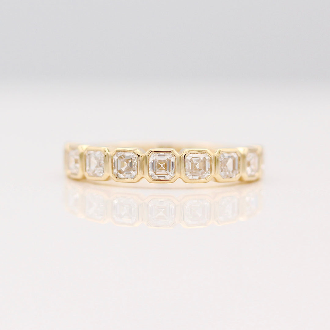 A Bezel set Yellow Gold Wedding Band with Asscher cut Diamonds.