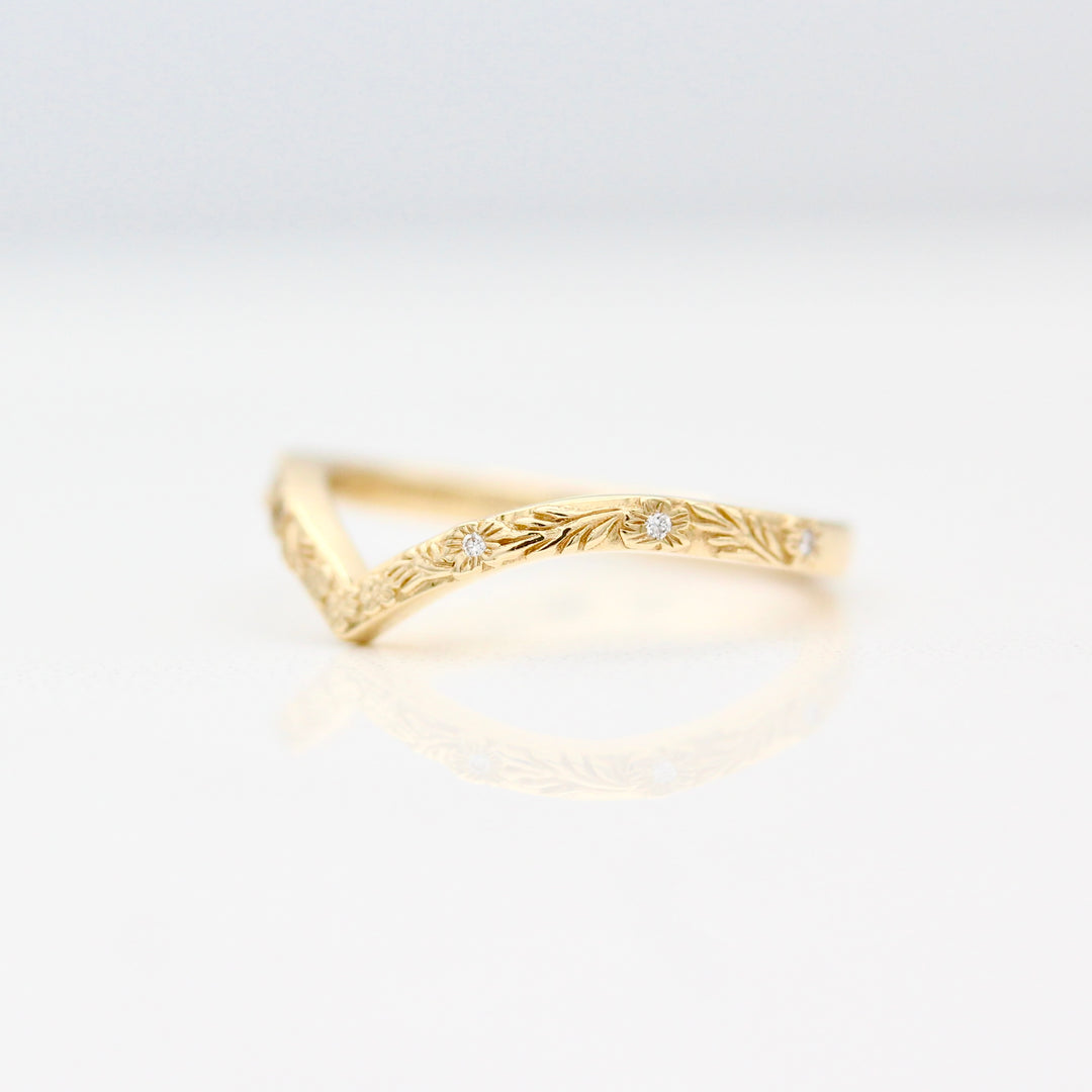 Angled view of the The Willow Wedding Band in Yellow Gold with inset Lab Grown Diamonds in the center of each Flower.