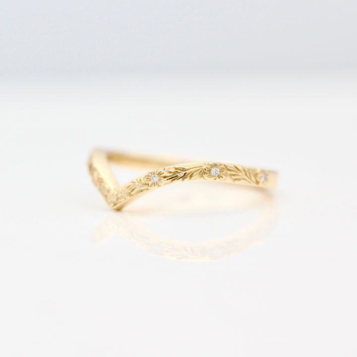 Angled view of the The Willow Wedding Band in Yellow Gold with inset Lab Grown Diamonds in the center of each Flower.