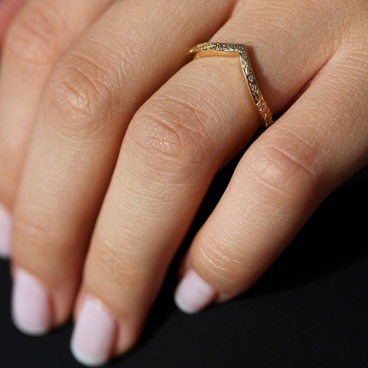The Willow Wedding Band in Yellow Gold on a Hand.