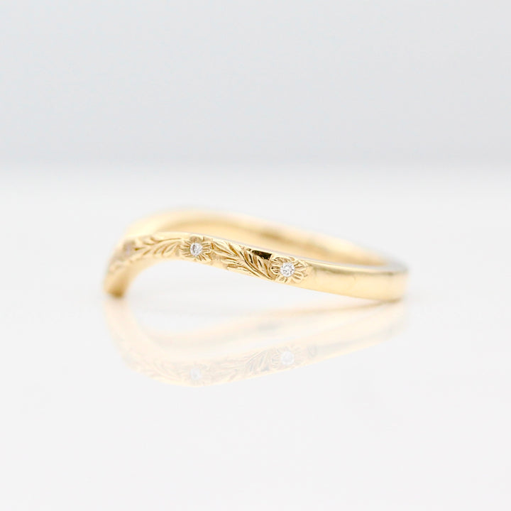 The side view of the V Shaped Wedding Band in Yellow Gold on a White Background.