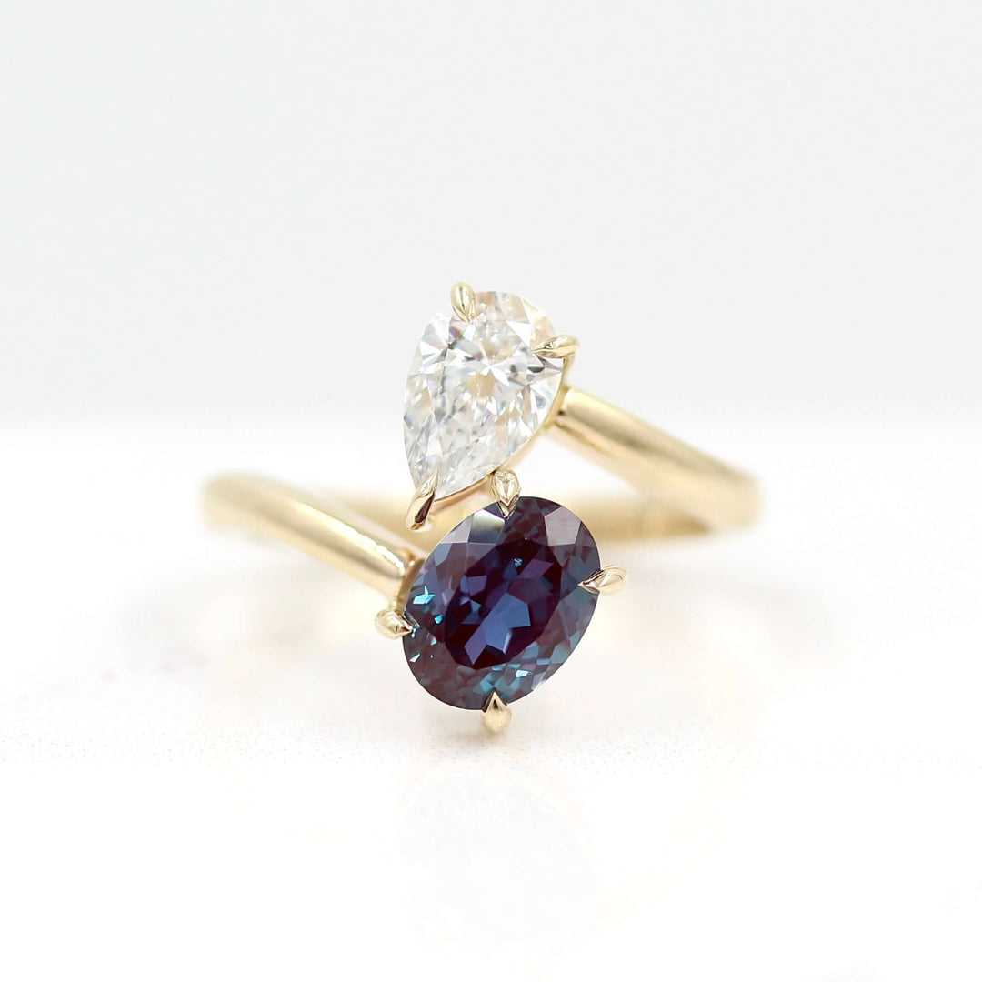 Toi et Moi Diamond and Alexandrite Bypass Ring in yellow gold against a white background