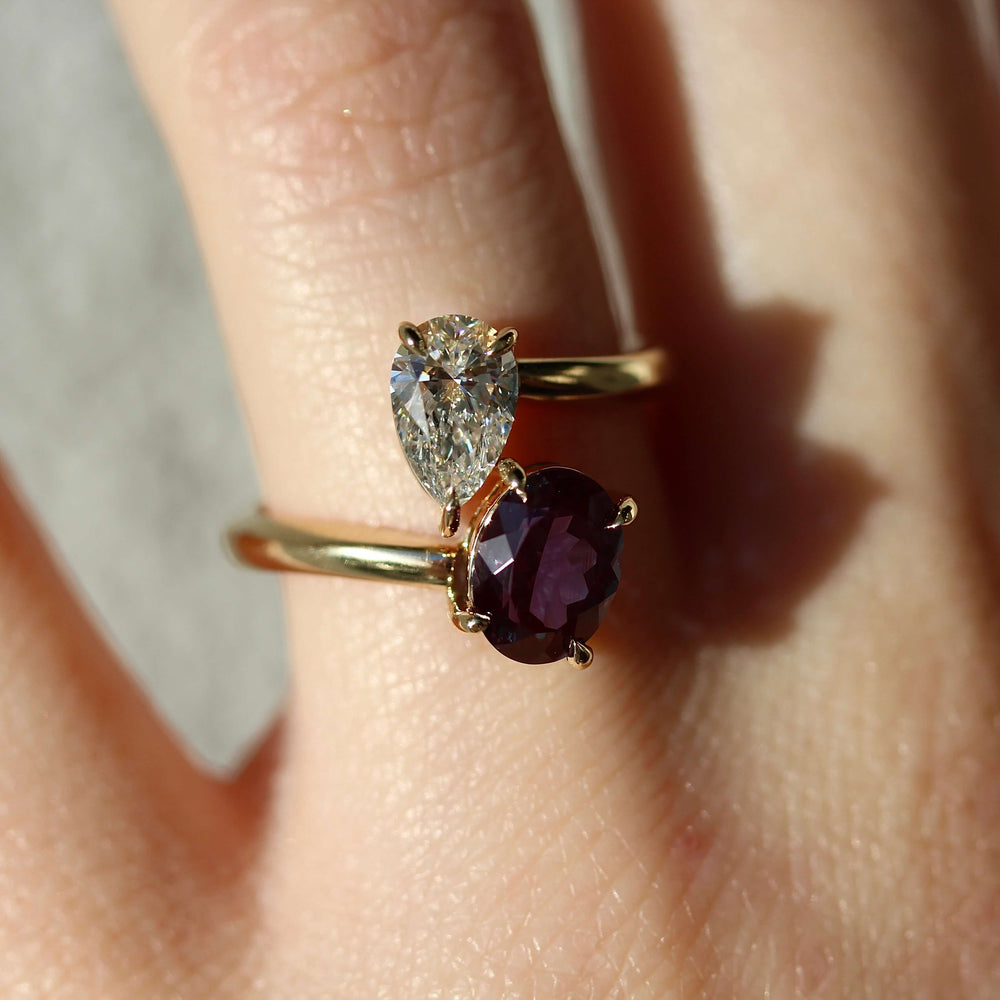 Toi et Moi Diamond and Alexandrite Bypass Ring in yellow gold modeled on a handd