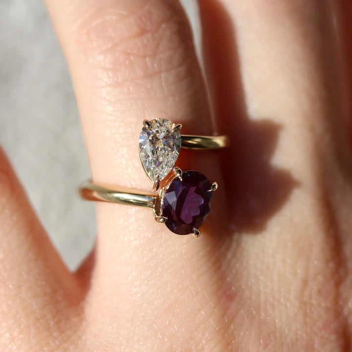 Toi et Moi Diamond and Alexandrite Bypass Ring in yellow gold modeled on a hand