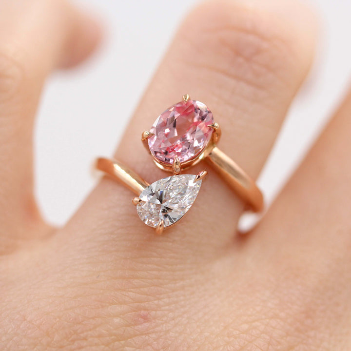 Toi et Moi Diamond and Peachy-Pink Sapphire Bypass Ring in Rose Gold modeled on a hand