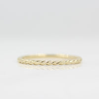 Dainty Twist Stacking ring in yellow gold against white background