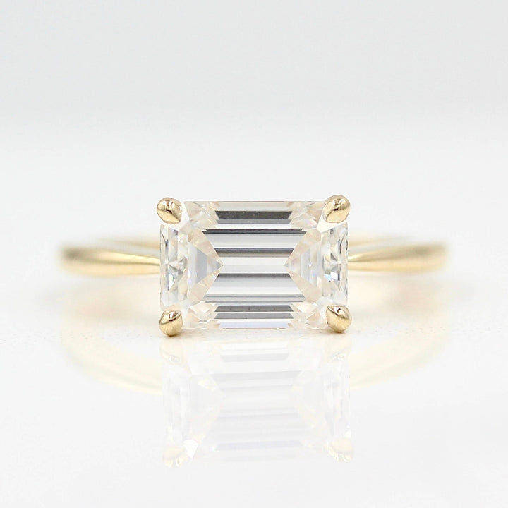 The Twyla ring emerald in yellow gold against a white background