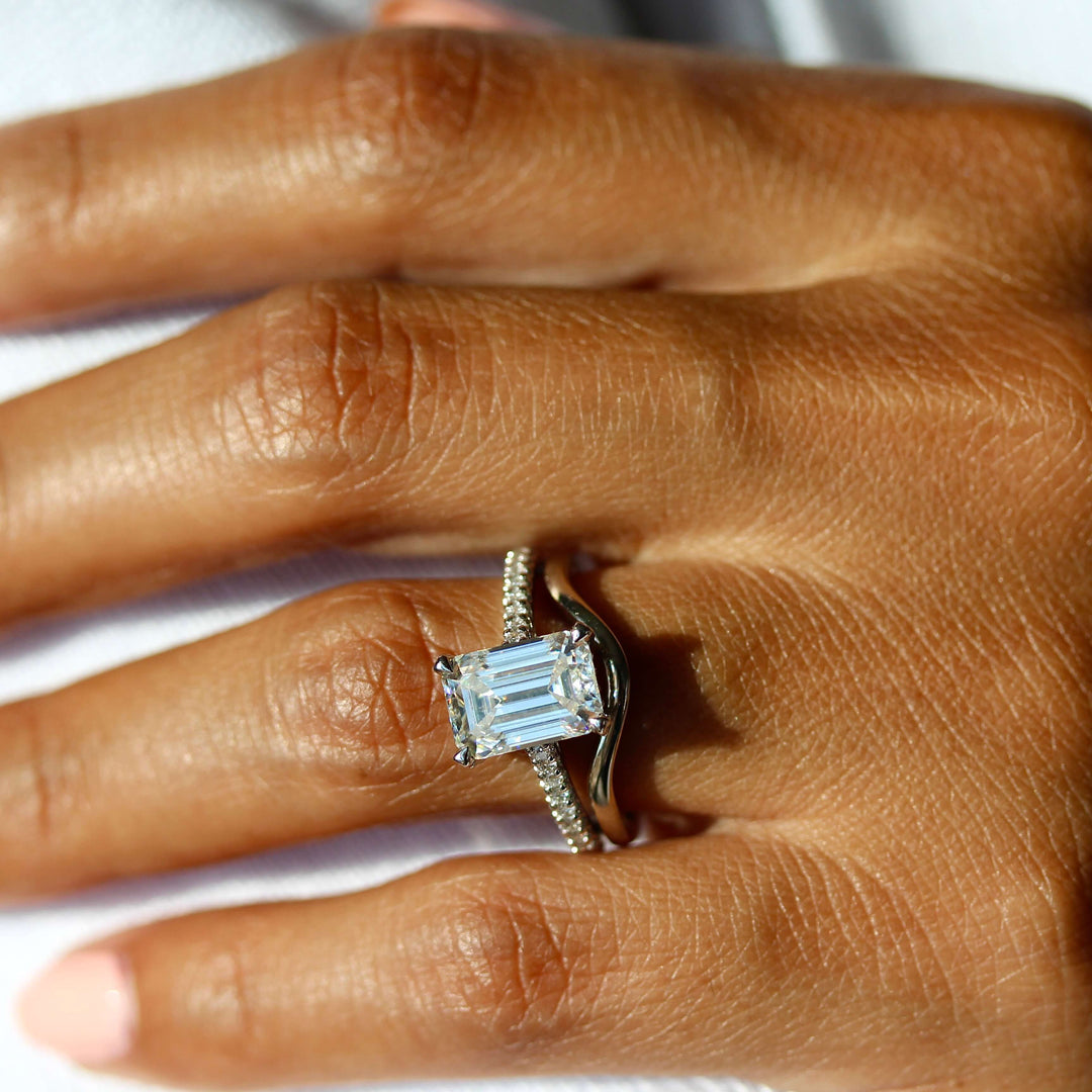 The Victoria Ring in White Gold stacked with the Wave wedding band in white gold modeled on a hand