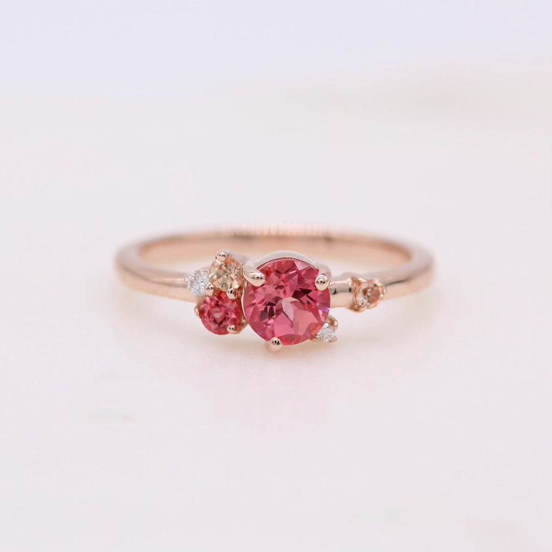 Pink sapphire cluster ring on white background
