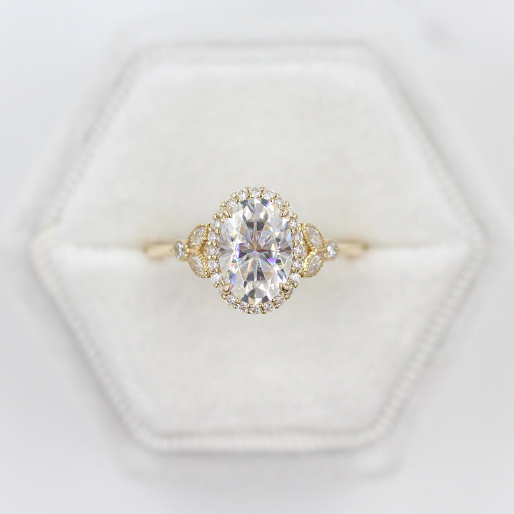 The Cate Ring (Oval) in yellow gold in a white velvet ring box