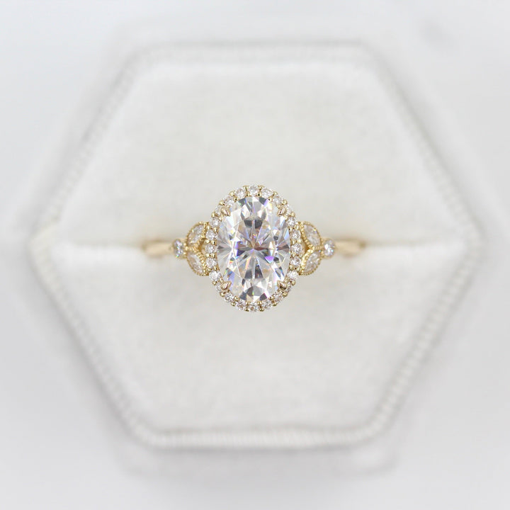 The Cate Ring (Oval) in yellow gold in a white velvet ring box