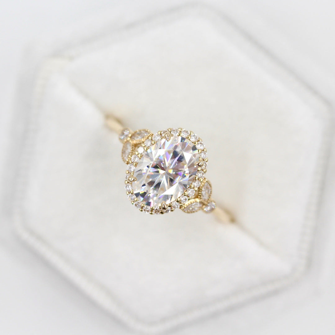 The Cate Ring (Oval) in yellow gold in a white velvet ring box