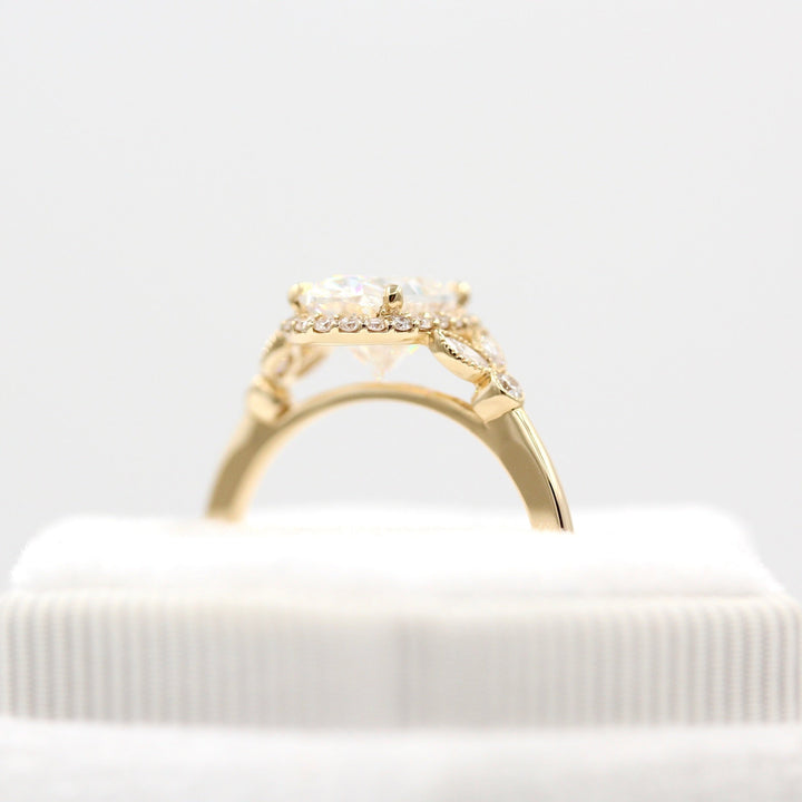 The Cate Ring (Oval) in yellow gold in a white velvet ring box