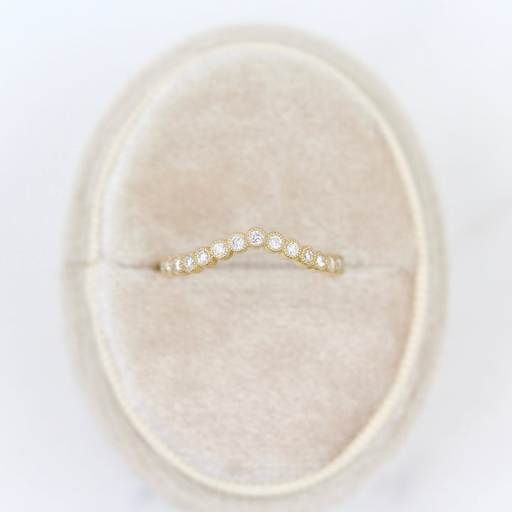 yellow gold contour band with milgrain detail in oval ring box