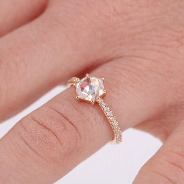 Hand wearing the aurora hexagon moissanite ring