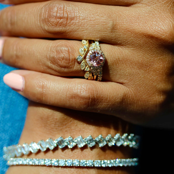 a model wearing a gemstone engagement ring and diamond bracelets