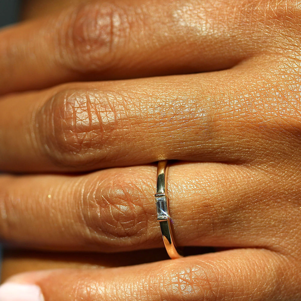 a model wearing a gold baguette ring