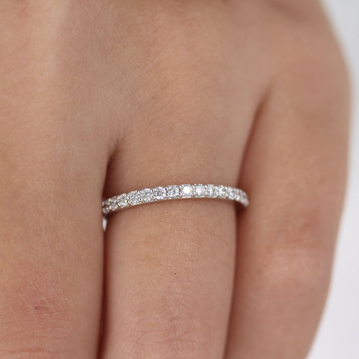 a model wearing a silver pavé wedding band
