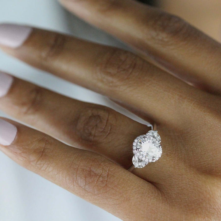 an oval ring with marquise side stones on a woman's hand.