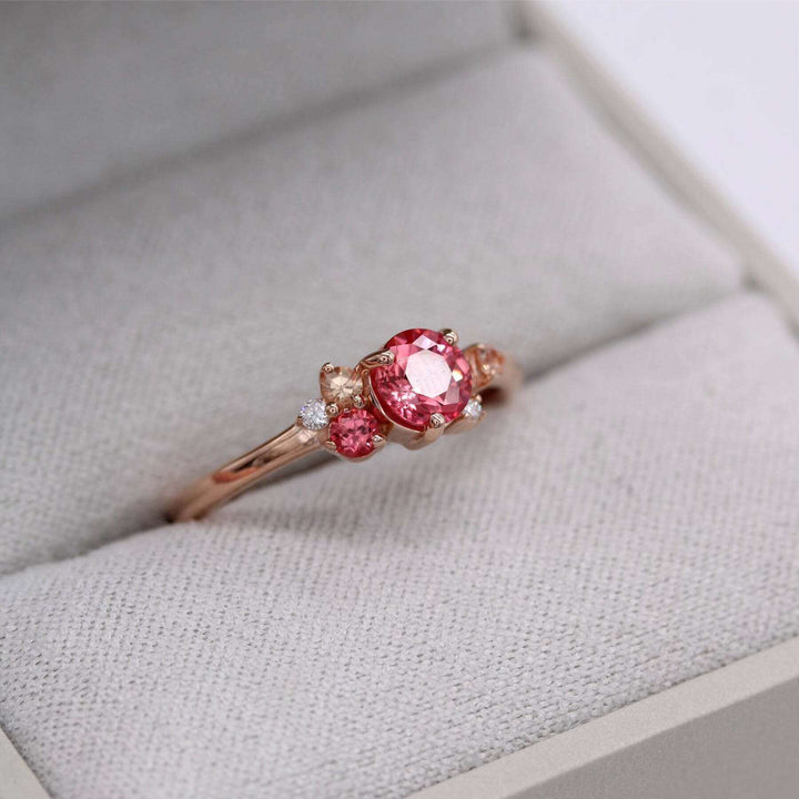 Pink sapphire cluster ring in gray ring box