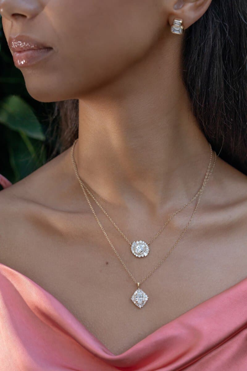 model wearing two lab-grown diamond necklaces and earrings
