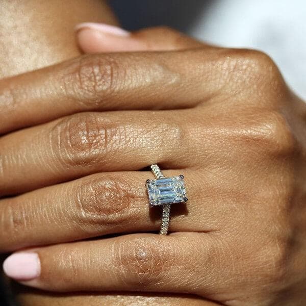 hand wearing pavé engagement ring