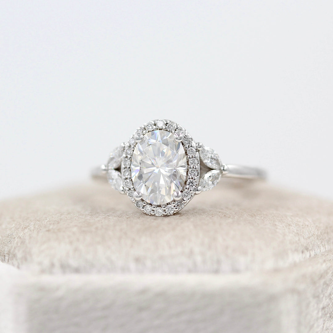 a white gold engagement ring atop a ring box.