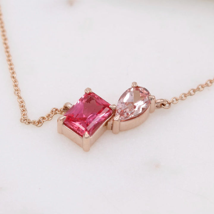 Close up of radiant padparadscha and pear peachy-pink created sapphire toi et moi necklace